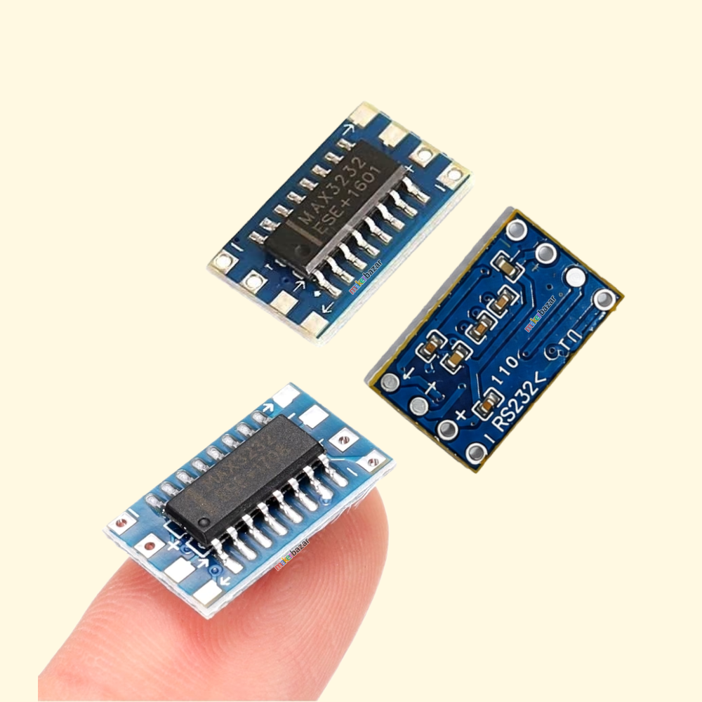 Three small blue electronic circuit board modules with integrated circuit chips are shown, with one module resting on a person's fingertip to demonstrate their tiny size against a pale cream background.