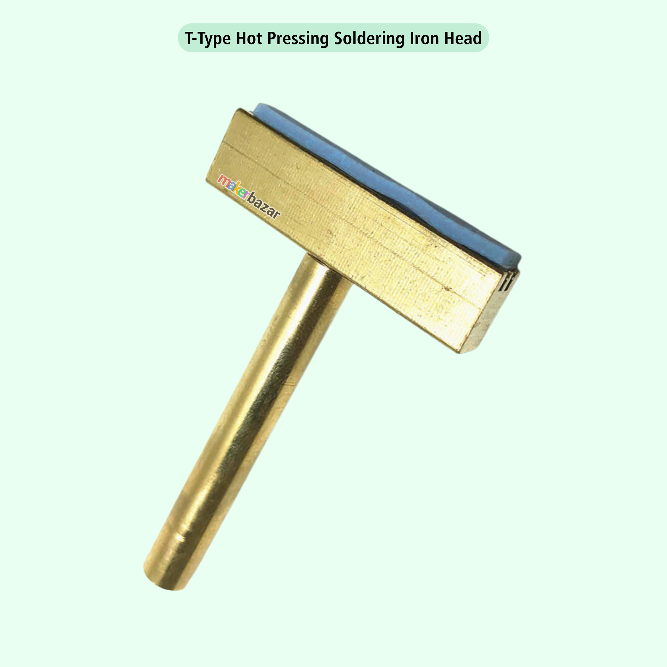 A T-type hot pressing soldering iron head with a brass-colored metal body, a blue rectangular element on top, and a small 'mks bazar' logo printed on the side, set against a pale mint green background with a text label at the top.
